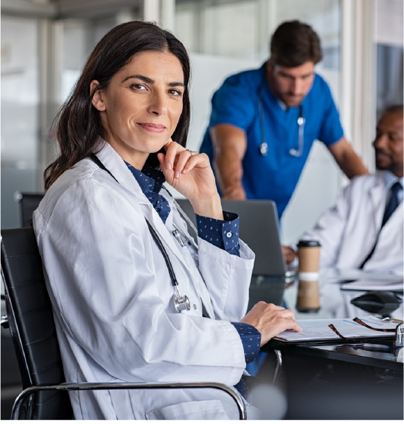 Female doctor sitting and looking at camera